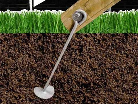 A timber post is fastened by the ground anchor.