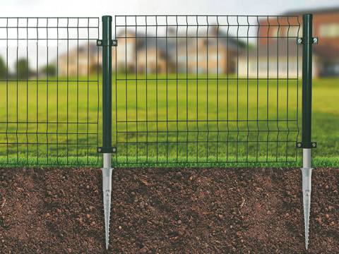 Several pieces of curvy wire mesh fence are fastened by the ground screws.