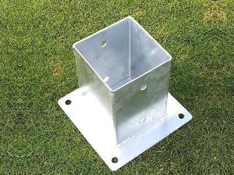A post base for square post on the grassland.