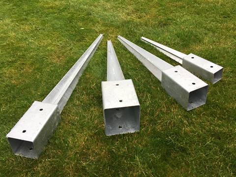 Four different specifications of post spikes lying on the grassland.